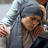 Woman with cancer looking at x-ray